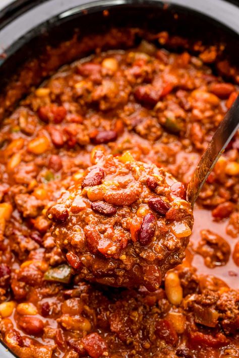 This Slow Cooker Chili is a hearty bowl of comfort food that's made with ground beef, three different kinds of beans, and dark chocolate! Let your slow cooker do all of the work for you and then pile on all of your favorite chili toppings before devouring! Smashed Beans, Meal Rotation, Chili Toppings, Kinds Of Beans, Chili Seasoning, Slow Cooker Chili, Dried Beans, Different Kinds, Work For You