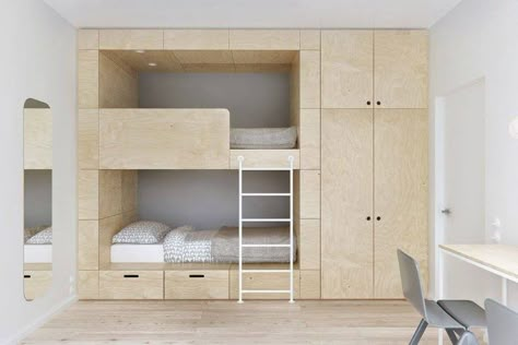 This bunk bed is clearly custom made and it shows that the bed area can have a wardrobe and lots of storage, leaving the rest of the room clear for play. They’ve even built in drawers under the bed which is perfect for toys that the kids can easily get to. http://petitandsmall.com/coolest-bunk-beds-kids-room/ Bed In, Design Ložnic, Modern Bunk Beds, Space Saving Beds, Closet Bed, Built In Bunks, Cool Bunk Beds, Bunk Beds With Stairs, Tiny Bedrooms