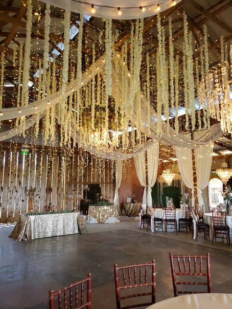 Fairy Lights Wedding Ceiling, Light Garland Wedding, Fairy Lights From Ceiling, Hanging Fairy Lights Wedding, Fairy Lights Ceiling Wedding, Fairy Light Ceiling Wedding, Flowers Falling From Ceiling, Fairy Lights Wedding Ceiling Lights, Ceiling Drapery With Fairy Lights