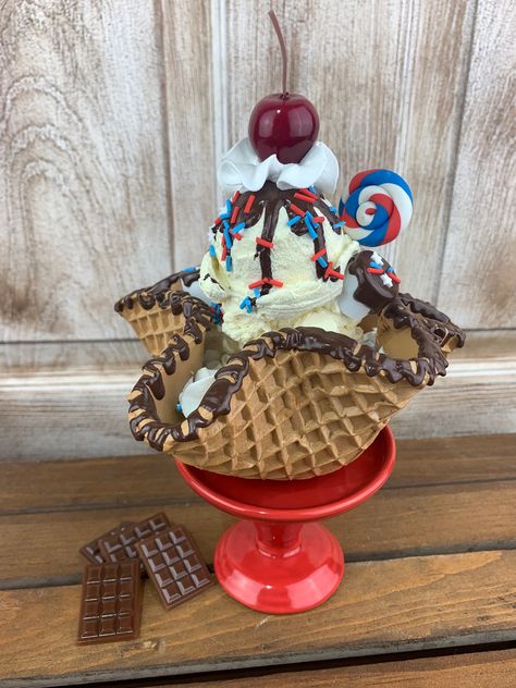 "This adorable faux dessert is perfect for your tiered tray, shelf or anywhere you want to add a little extra \"cuteness\"! This fake waffle bowl is just an  adorable red white and blue summer decoration . It's is about 6\" wide by about 5\" tall. It even has faux sprinkles that look so real!!  But don't try to eat it!! It's just for decoration!!  Phoro props and cupcake stand are NOT included! This listing includes one waffle bowl ONLY!  Please keep away from children!!   Don't forget to check Ice Cream Decor, Fake Ice Cream, Waffle Bowl, Ice Cream Decorations, Fake Food Props, Cream Decor, Patriotic Desserts, Fourth Of July Decor, Food Props