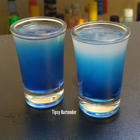 SEXY BLUE EYES 1 oz. (30ml) Blue Raspberry Vodka (Don't Use UV Blue, it must be clear) 1/2 oz. (15ml) Peach Schnapps 1/2 oz. (15ml) Lime Juice  Shake with ice and pour  Mix 1/2 oz Blueberry Schnapps and 1/2 oz Simple Syrup then drizzle in to make the blue gradient. Uv Blue Drinks, Raspberry Vodka, Uv Blue, Blue Drinks, Tipsy Bartender, Peach Schnapps, Fancy Drinks, Raspberry Lemonade, Drinks To Try