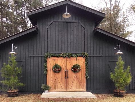 Beautiful black barn with stained barn doors and barn lights. Barn Light Electric, Barn Shop, Outdoor Barn Lighting, Best Barns, Barn Renovation, Barn Garage, Black Barn, Barns Sheds, Metal Barn