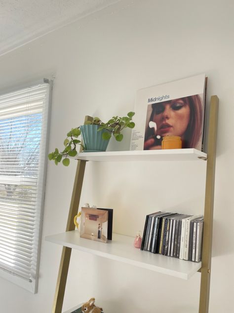 Shelves Aesthetic Room, Ladder Shelf Aesthetic, Ladder Shelves Bedroom, Ladder Shelf Decor Ideas, Subtle Taylor Swift Room Decor, Taylor Swift Apartment Decor, Taylor Swift Vinyl Shelf, Aesthetic Ladder Shelf, Swiftie Room Ideas