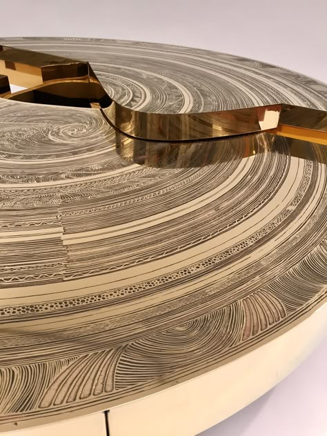 Coffee table - Exclusive piece - 2016 - Engraved brass - Ø 150cm x H 33cm/26cm MAISON ARMAND JONCKERS, One Name, three Creators… A family story that unites two generations of designers. For over 5 years now, Alexandra and Grégoire revisit and highlight their father's work, the sculptor Armand Jonckers, through new creations at the frontiers of design and art. From time to time, Armand, Alexandra & Grégoire likes to play and repeat old models like the famous iconic "Jardinière". Set Of Coffee Tables, Family Story, Light Sculpture, Stone Sculpture, Stone Gold, Coffee Table Setting, Works Of Art, Tile Design, Small Designs