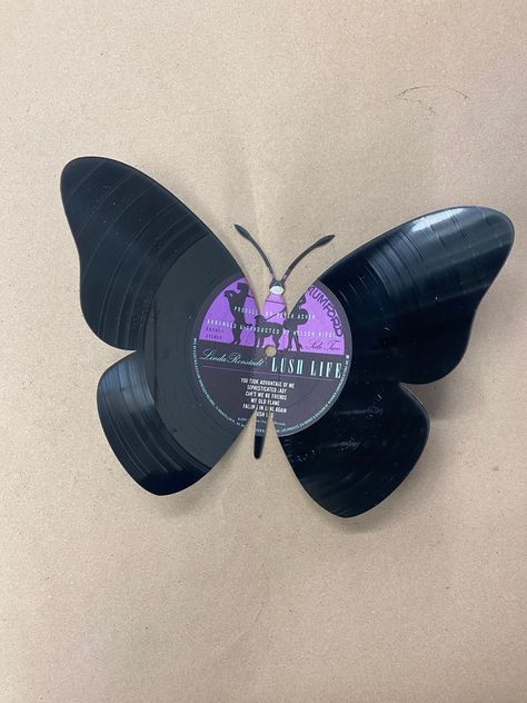 "the butterfly is laser cut and bent to give it that one of a kind look. It is 9 1/2\" wide when bent and almost 7\" tall Made from used records, the album is chosen at random. Our vinyl art is cut by with our laser, we can get pretty creative and detailed with the designs. All of our items are made local in the USA, by us Buffalo Customs. You guessed it right in Buffalo NY. We use a precision laser to cut or engrave our products. We do offer local pick up at our retail location, or we can ship Vinyl Record Butterflies, Cool Vinyl Designs, Crafts With Records Vinyls, Painted Vynal Records, Painted Vinyl Records Aesthetic, Record Art Ideas, Vinyl Painting Ideas, Unique Room Ideas, Vinyl Collage