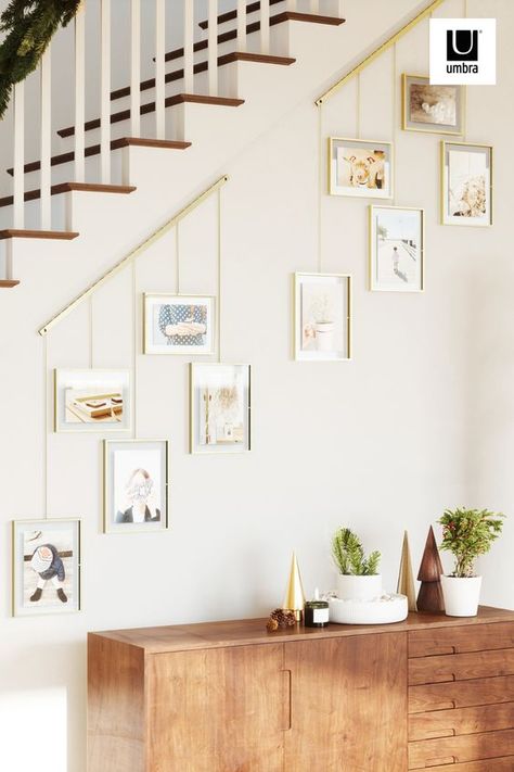 wall mounted brushed metal ledge with clips and brackets to hold five gallery style picture frames of various size Photo Wall Entryway, Decorating Stairway Walls, Stairway Gallery, Stairway Gallery Wall, Angled Wall, Picture Wall Living Room, Wall Entryway, Gallery Wall Staircase, Family Gallery Wall