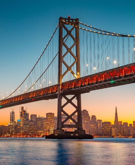 🌆 #SanFranciscoSunset 🌉 Capture the San Francisco skyline at sunset with the Oakland Bay Bridge, highlighting the city’s iconic landmarks in a stunning evening scene. What’s your favorite city skyline at sunset? Oakland Bay Bridge, Iconic Landmarks, Bay Bridge, Favorite City, City Skyline, San Francisco Skyline, The City, San Francisco, Bridge