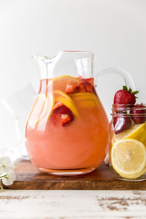 Pink Lemonade Sangria | KJ and Company -Pink Lemonade Sangria is a fun, vibrant beverage! A bottle of rosé is swirled together with fresh strawberries, zesty lemon slices and sweet pink lemonade. This is a cocktail to pucker your lips for! Each glass will have you sitting back to relax and kicking off your shoes for some porch-time swinging. Get the recipe on https://kjandcompany.co #recipe #cocktail #sangria #drinks #lemonade #pinklemonade #strawberry Pink Lemonade Sangria, Lemonade Sangria Recipe, Strawberry Lemonade Sangria, Charcuterie Lunch, Drinks Lemonade, Lemonade Sangria, Pink Sangria, Kid Friendly Drinks, Rose Sangria