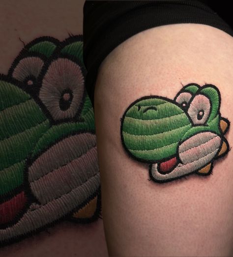 Embroidery patch tattoo of Yoshi from early this year! Sooooo cool to do this! Would you get an embroidery tattoo? Let me know in the poll below 👇🏻 FUN FACT: Yoshi can change colour. The character’s colour is one of the key features that makes him so memorable. But Yoshi isn’t always green, and many might not know that he has colour-changing abilities. __________________________________________ Sponsored by: @stencilstuff #bodyart #embroiderypatch #colourrealism #yoshitattoo #supermario #nin... Mario And Yoshi Tattoo, Yoshi Tattoo Design, Yoshis Island Tattoo, Yoshi Tattoos Ideas, Yoshi Tattoo, All Yoshi Colors, Embroidery Tattoo, Embroidery Patches, Friend Pictures