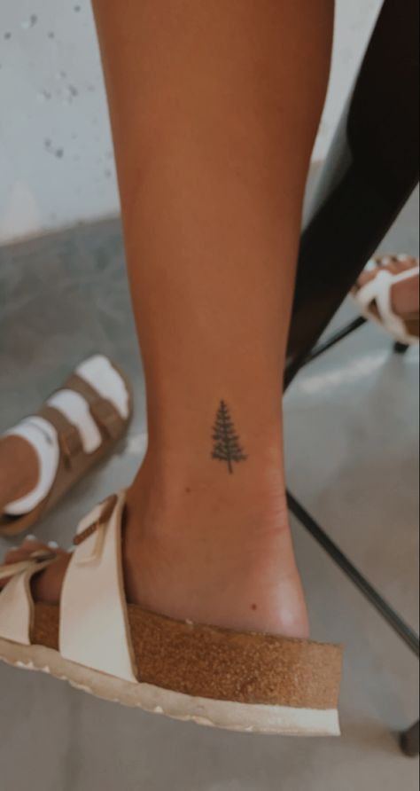 Pine Tree Ankle Tattoo, Dainty Pine Tree Tattoo, Simple Christmas Tattoo, Dainty Tree Tattoo, Simple Camping Tattoo, Simple Pine Tree Tattoo, Loon Tattoo Ideas, December Tattoos Ideas, Fine Line Pine Tree Tattoo