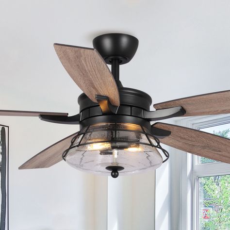 This 52 in indoor modern iron ceiling fan is a perfect show piece. The clean lines and modern style is outfitted with a blade finish. The chandelier ceiling fan features a lantern-style light fixture with two E26 bulbs, energy-efficient bulbs encased in seeded glass. It is rated for use indoor spaces like living rooms, bedrooms and kitchens. It also comes with a handheld remote for easy control of the fan speed and direction as well as lighting. Parrot Uncle 52-in Matte Black with Brown Blades Indoor Ceiling Fan Light Kit Compatible and Remote (5-Blade) | F6311110V Farmhouse Style Ceiling Fan Living Room, Bedroom Farmhouse Ceiling Fan, Farmhouse Ceiling Fan Living Room, Ceiling Fans For Living Room, Bedroom With Ceiling Fan Ideas, Kitchen Ceiling Fans With Light Ideas, Kitchen Ceiling Fans, Ceiling Fans With Light Living Room, Modern Ceiling Fans Living Room