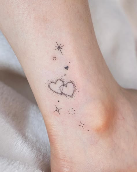 31 Small Ankle Tattoos Ideas for Girls & Women - Style Shepherd Taylor Swift Ankle Tattoo, Star Tattoos On Ankle, Delicate Heart Tattoo Feminine, Hand Star Tattoos For Women, Stars And Hearts Tattoos, Sparkle Heart Tattoo, Hearts And Stars Tattoo, Star And Heart Tattoo, Ankle Tattoo Designs Unique