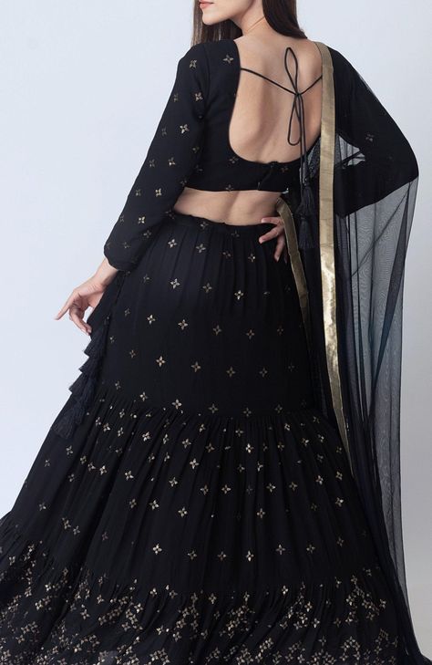 This luxurious Georgette Asha Black Lehenga Choli Set is a refined choice for special occasions that call for classy look. The black lehenga, crafted from premium georgette, features intricate all-over gold sequins embroidery. Complementing the tiered lehenga is a matching georgette blouse adorned with coordinating all-over gold sequins embroidery to create a harmonious look. The Asha Black Lehenga Choli set is completed with a black net dupatta that is beautifully accented with a golden border. The rich interplay of black and gold, combined with the premium georgette fabric, ensures a flattering fit and an effortlessly classy appearance of the Asha Sequins Embroidered Black Lehenga Choli Set. No. of Components: 3 Sequins embroidery on blouse & lehenga Blouse has hook & eye back closure Ti