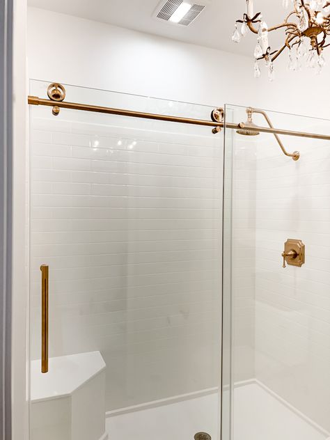 The Most Beautiful Shower Door Ever - Deb and Danelle Modern Sliding Shower Door, Glass Shower Door With Golden Trim, Glass Shower Sliding Door, Master Shower Glass Door, Walk In Shower With Gold Fixtures, Slide Glass Shower Door, Gold Glass Shower Door, Bathroom With Sliding Shower Door, Best Shower Doors