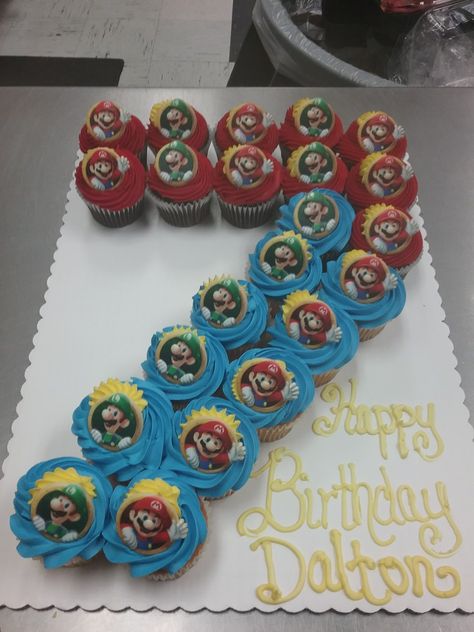 Cupcake cake number 7 with Mario rings #7 Cake, Mario Birthday Cupcake Cake, Super Mario Pull Apart Cupcake Cake, Cupcake Cakes Birthday Boy, Number 7 Pull Apart Cupcakes, 7 Cupcake Cake Number, Number 7 Cupcakes, Super Mario Number Cake, Mario Birthday Party Cake Easy