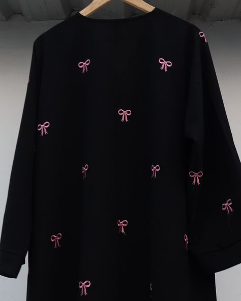 Introducing our Black Abaya with Pink Bow Embroidery! 🎀✨ This abaya effortlessly combines timeless elegance with a touch of modern flair. Made from luxurious black fabric, it’s elevated by the adorable pink bow embroidery. 🌸 Perfect for both casual outings and special occasions, this trendy piece is designed to stand out while keeping you comfortable. Meticulously crafted to ensure quality and style in every stitch. Step up your modest fashion game with Malikah. 💫 #malikahmodestwear #bowa... Pink And Black Abaya, Bow Abaya Pink, Traditional Black Abaya With Resham Embroidery, Black Abaya Embroidery Design, Traditional Black V-neck Abaya, Black Embroidered Floor-length Abaya, Black Abaya, Cute Polymer Clay, Pink Bow