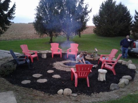 Took down the pool and made a huge fire pit area. Added black mulch, fire pit with block and pea gravel. Used rocks and stepping stones. Not bad for $75.00. The only thing we purchasrd was the pea gravel and mulch. Backyard Firepit Area, Inexpensive Backyard Ideas, Outdoor Fire Pit Area, Pea Gravel Patio, Fire Pit Materials, Living Pool, Mulch Landscaping, Fire Pit Landscaping, Gravel Patio