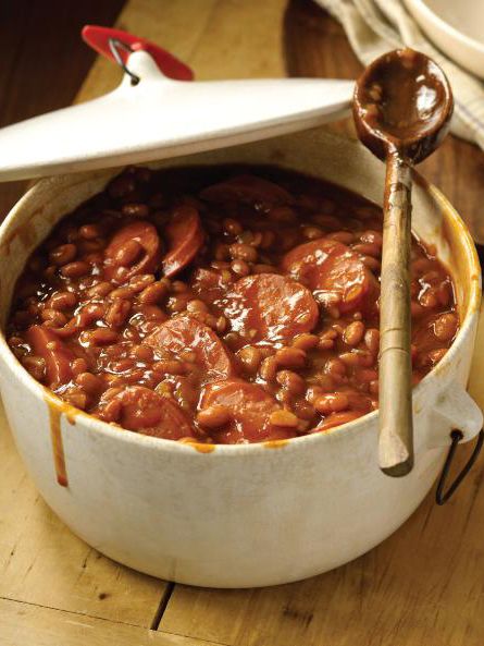 BAKED BEANS: 2 tablespoons canola oil 1 large onion, finely chopped 3 cloves garlic, finely chopped 1/2 pound smoked sausage, sliced Three 16-ounce cans pork and beans 1/2 cup ketchup 1/2 cup light molasses 1/4 cup light-brown sugar 2 tablespoons apple-cider vinegar 2 tablespoons prepared mustard Dash of hot sauce, preferably Tabasco Southern Baked Beans, Bbq Side Dish Recipes, Bbq Baked Beans, Baked Beans Recipe, Baked Bean Recipes, Beans Recipe, Smoked Sausage, Baked Beans, Bean Recipes