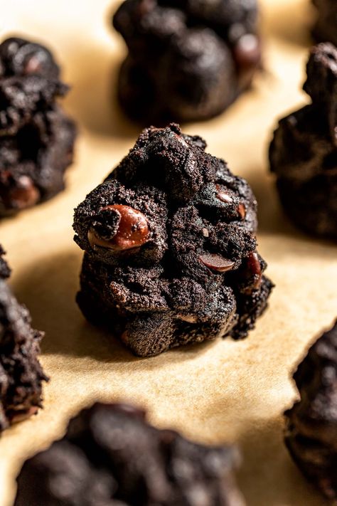 Being on Santa's Naughty List has never been sweeter! These Lumps of Coal Cookies have craggy edges, a fudgy center, and rich flavor from black cocoa and bittersweet chocolate chips. Rolled in sugar and baked just until set, they’re the perfect treat for holiday cookie plates or festive hot cocoa breaks! #lumpofcoal #lumpofcoalcookies #christmascookies #christmascookieideas #christmascookieexchange #holidaytreats #holidaybaking #cookierecipes #blackcocoapowderrecipes #blackcocoacookies Coal Cookies, Lumps Of Coal, Lump Of Coal, Cocoa Powder Recipes, Black Cocoa, Cocoa Cookies, Christmas Cookie Exchange, Desserts For A Crowd, Holiday Cookie