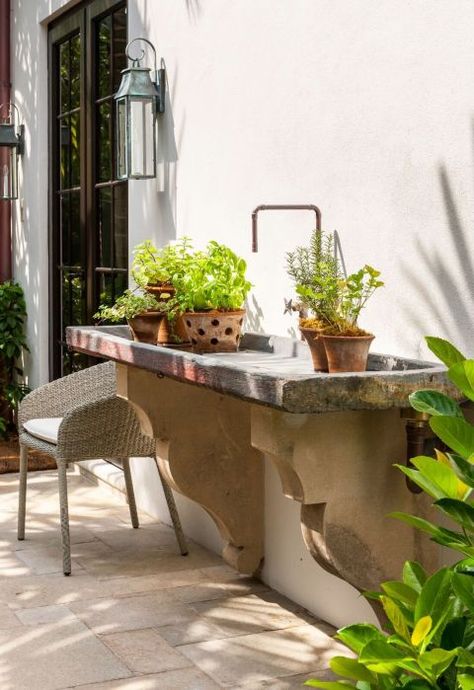 Kavanaugh's client stumbled upon this old slate sink while traveling in California. "The corbels below were reclaimed off an old building in Palm Beach," she explains. "We had a plumber fit copper pipe to feel authentic and rustic. It's great as potting table or to put ice and bottles of wine in for a party!" Sconce, Urban Electric Company, urbanelectrico.com . Chair, Janus Et Cie Strada Collection, janusetcie.com . Lavabo Exterior, Outdoor Garden Sink, Outside Sink, Outdoor Kitchen Sink, Garden Sink, Potting Table, Outdoor Sinks, Concrete Sink, Concrete Garden