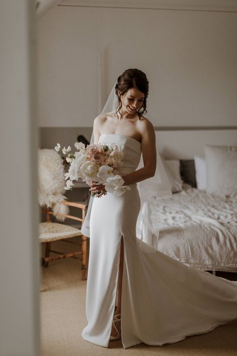 brunette bride in elegant and contemporary wedding gown holding her bouquet at Gardswell farm Bride Holding Bouquet, Fresh Makeup Look, Brunette Bride, Holding Bouquet, Brides Hair, Fresh Makeup, From Miss To Mrs, Makeup Services, Wedding 2024