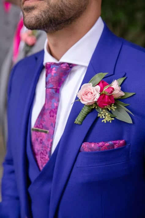 Tom's cobalt blue suit showed off his personality in a bold way on his wedding day at CJ's Off the Square. // Photo by Evin Photography // Suit by Indochino // #groom #groomsmen #groomstyle #boutounierre #bluesuit #powersuit #bluewedding #navywedding #realwedding #realweddings #nashvillewedding #nashvilleweddings #weddingflowers #weddingflorist #weddingphotography #detailshots #weddingdetails #floraltie Bright Blue Tuxedo Wedding, Sapphire Blue Suit Groom, Royal Blue And Magenta Wedding, Bright Blue Wedding Suit, Bright Blue Suit Wedding, Groom Colorful Suit, Bright Blue Groomsmen Suits, Colourful Groom Suit, Cobalt Blue Suit Men