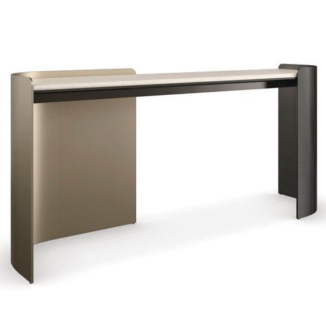 With an inherent rhythm and sleek design, the Caracole Movement console is fluid in both form and function. Artfully integrating sensual curves with muted lines, a Creme Travertine stone top is balanced on metal legs in contrasting bronze finishes for added drama. Makes an alluring statement in halls, entryways, and home offices as a minimalist desk. 68in W x 16.75in D x 31in H Finish: Chocolate Bronze, Lucent Bronze Metallic Material: Metal, Stone Crème Travertine stone top. Left metal leg fini Sleek Console, Designer Console Table, Unique Console Table, Contemporary Console, Evil Eye Art, Metal Console Table, Minimalist Desk, Metal Console, Travertine Stone