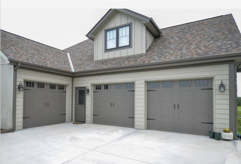 The exterior walls are Intellectual Gray (SW 7045) and the trim is Porpoise (SW 7047). Grey Garage Doors, Gray Garage, Intellectual Gray, Grey Exterior House Colors, Gray House Exterior, House Paint Color Combination, Garage Door Makeover, Exterior House Paint Color Combinations, Exterior House Color