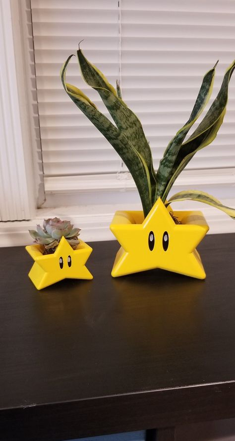 "Super Mario Super Star Planter!!  Kirbys Star Planter. Accepts all types of plants from succulents to medium sized indoor/ outdoor plants.  Style how you see fit Small is great for Succulents  Aloe, Echeveria.  Large is great for Snake plants, Dracaena's 2 Sizes Available Small 2.5\" Tall X 3\" Wide Large 4.25\" Tall x 5\" Wide Plants not included" Plant Decorated Room, Mario Bathroom Decor, Gamer House Decor, Kirby Planter, Unique Plant Pots, Clay Plant Holder, Room Plants Decor, Cool Home Decor Ideas, Funky Planters