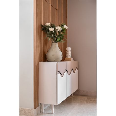 Keeping in line with the Japandi aesthetic, we created a minimalist cabinet with defining waves and colour blocked it. The chic cabinet added charm to this compact entryway with a wooden wall panel behind it acting as a great backdrop. The wall panel apart from adding aesthetically, also masks an unsightly MCB box.   #studioipsa #foyer #foyerdesign #foyerdecor #interiordesign #interiorstyling #homedecor #foyerdesign #foyerenterance #foyerconsole #compactenterance Foyer Console Table Decor, Foyer Console Table, Foyer Console, Japandi Aesthetic, Minimalist Cabinet, Console Table Decorating, Entry Design, Wooden Wall Panels, Foyer Decor