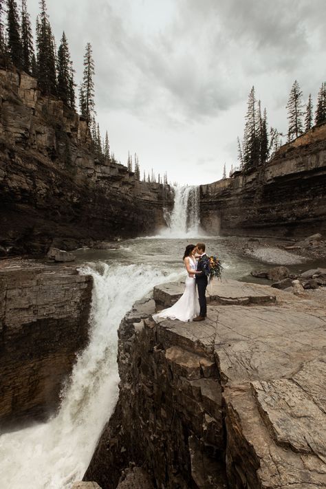 For this Nordegg Heli Elopement in Alberta, Canada our first stop was this amazing waterfall! We hiked down to this special spot and took the most amazing elopement photos in front of this magical landscape. Elopement Canada, Heli Elopement, Nordegg Alberta, Bc Elopement, Alberta Elopement, Clifftop Wedding, Banff Elopement, Amazing Waterfall, Waterfall Elopement