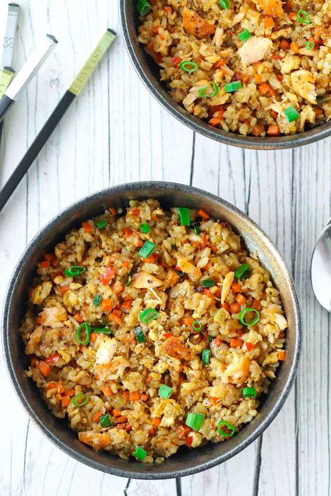 This Garlic Salmon Fried Rice is easy to make, great for meal prep, and incredibly tasty! It’s deliciously garlicky, loaded with protein thanks to salmon and eggs, and tossed in a mouthwatering and fragrant sesame chili soy sauce! #friedrice #salmonfriedrice #chinese #dinner #japanese #takeout #asian #easyfriedrice #mealprep #weeknight | That Spicy Chick Salmon Rice Balls, Japanese Takeout, Chili Soy Sauce, Salmon Fried, Dinner Japanese, Salmon Fried Rice, Japanese Fried Rice, Chinese Dinner, Flaked Salmon