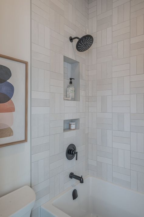 The shower surround features a subway tile, installed in a basket weave pattern. Basketweave Subway Tile Backsplash, Double Basket Weave Tile, Subway Tile Basketweave Pattern, Basket Weave Tile Shower Wall, Double Basket Weave Subway Tile, Basket Weave Shower Tile, Basket Weave Tile Pattern, Unique Subway Tile Patterns, Basket Weave Tile Shower