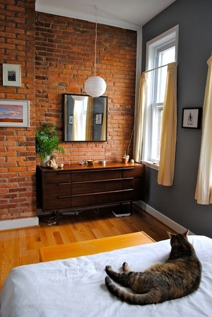 Nice join between the brick and the plaster wall. Also, I love the grey paint with the yellow curtains. Brick Wall Bedroom, Apartment Therapy House Tours, Brick Wall Ideas, Brick Interior Wall, Interior Brick, Brick Ideas, Grey Wood Floors, Brick Interior, Studio Loft