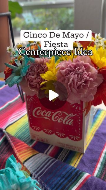 Need a quick & easy decor idea for a Fiesta Party pr Cinco De Mayo in May? Don't throw away your Mexican Cola carrier instead create a beautiful, colorful floral arrangement! #cincodemayo #fiestaparty #diydecor #diyparty #fiestaparty #tacoday #floral #centerpiece #intentionalparty #intentionalcelebration #partytheme #party #may5th #tacos Mexican Floral Arrangements, Mexican Party Centerpiece, Mexican Centerpiece Ideas, Mexican Centerpiece, Taco Party Decorations, Colorful Floral Arrangement, Easy Decor, Taco Party, Fiesta Theme