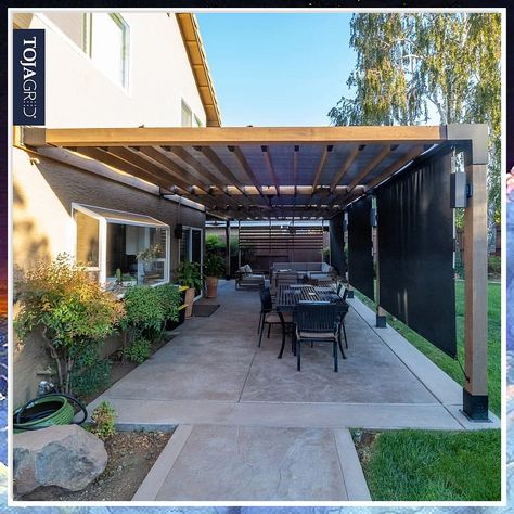 Discover the most stunning pergola attached to house ideas for outdoor living. Transform your backyard with these beautiful and functional designs. Create a cozy outdoor space with a pergola that seamlessly blends with your home. Perfect for entertaining or relaxing in style. Slanted Pergola Attached To House, Pergola Connected To House, Pergola Against House, Patio Awning Attached To House, Contemporary Pergola Designs, Metal Pergola Patio Ideas, Modern Patio Cover, Attached Pergola Ideas, Backyard Shade Structure