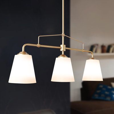 This Wistcross 3 - Light Shaded Linear Chandelier features a linear design that brings a modern and luxe aesthetic to your space. Made from metal with a gold finish for plenty of glam style, it includes a streamlined rod that connects to a horizontal bar and three separate holders. Each of these holders attaches to a white fabric empire shade that tempers the light from a single 60W bulb (sold separately). We love that the download is height-adjustable to better suit the size of your room, and i Light Over Island Kitchen, Linear Kitchen, Luxe Aesthetic, Chandelier White, Fabric Empire, Modern Lighting Chandeliers, Island Chandelier, Kitchen Island Chandelier, Linear Design