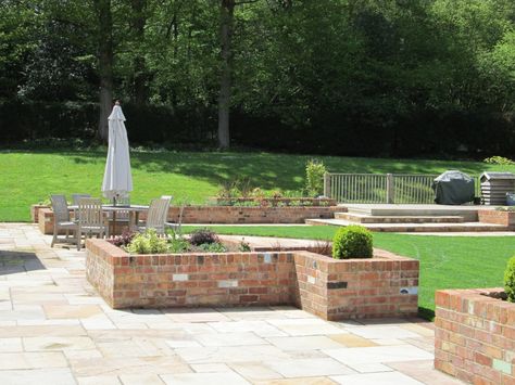 Garden with Reclaimed Brick Planters, Steps and Indian Sandstone Paving Stair Planter, Brick Planters, Reclaimed Brick Patio, Hanging Patio Lights, Terraced Gardens, Brick Ideas, Brick Planter, Indian Sandstone, Patio Furniture Makeover