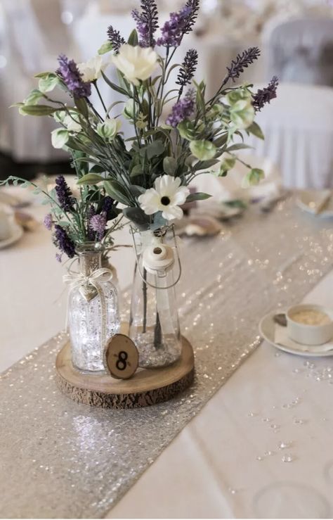 Lavender Plant Centerpiece Wedding, Lilac Wedding Centrepiece, Rustic Lilac Wedding Decor, Lavendar Table Setting Wedding, Lavender Table Arrangements, Lavender And Baby Breath Centerpieces, Lavender Table Centerpieces, Centerpieces Wedding Lavender, Lavendar Wedding Centerpieces