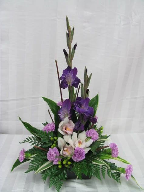 Glads, orchids & moon carnations. www.carolynsfloraldesigns.com Gladiolus Arrangements, Fresh Flower Arrangement, Contemporary Flower Arrangements, Tropical Floral Arrangements, Tropical Flower Arrangements, Easter Flower Arrangements, Purple And White Flowers, Large Flower Arrangements, Flower Arrangement Designs