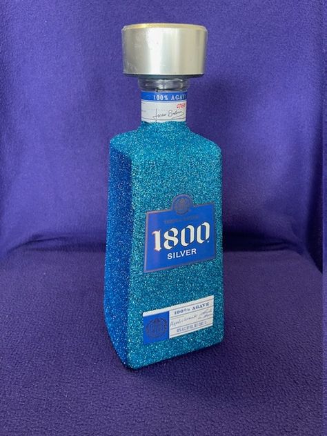 This two-toned, blue 1800 Silver tequila bottle (empty) is a fun way to display your alcohol, flowers, etc. Malibu Bottle, 1800 Silver Tequila, Alcohol Bottle Decorations, Bedazzled Bottle, Alcohol Bottle Crafts, Decorated Liquor Bottles, Bling Bottles, Liquor Bottle Crafts, Pretty Alcoholic Drinks