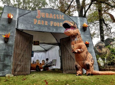 #parkforesthalloween Jurassic park theme Halloween yard decorations t-Rex costume.  Gates are painted cardboard zip tied to the structure of a canopy tent. Jurassic Park Birthday Party, Jurassic Park Party, Jurassic Park Birthday, Trunk Or Treat Ideas, Halloween Camping, Dinosaur Halloween, Jurrasic Park, Park Birthday, Halloween Yard Decorations