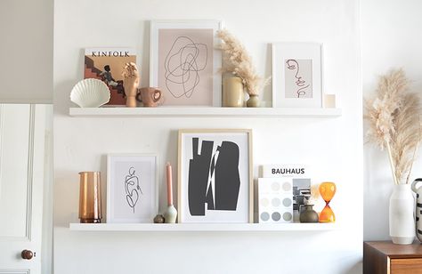 tips on styling a picture ledge Ikea Mosslanda Shelf Ideas, Picture Ledge Sizing Guide, Styling Ledge Shelves, Photo Ledge Decor, Styling Picture Shelves, 60 Inch Picture Ledge Layout, How To Style A Picture Ledge, Photo Ledge Above Bed, Photo Ledge Display Layout