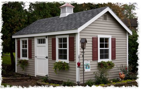 Tan house & maroon shutters House Schemes, Storage Barn, Red Shutters, Tan House, Shutter Colors, White Siding, Navajo White, Log Siding, Outdoor Shop