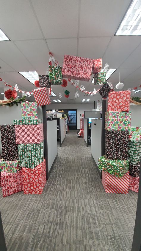 Wrapped boxes with gift wrap from the dollar tree, stacked them, then hung others with fishing line from the ceiling grid Hanging Presents From Ceiling, Christmas Decor Ideas For Office, Cubicle Christmas Decorations Contest, Office Christmas Decorations Ideas, Office Christmas Decorations Cubicles, Christmas Desk Decorations, Christmas Cubicle, Christmas Cubicle Decorations, Christmas Decorations Ideas