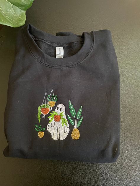 "Plant loving Ghost" embroidered on Gildan sweatshirt.  **SHIRTS ARE UNISEX** If you are wanting more of a relaxed fit, I would go up a size. If you are wanting a more fitted look, I would stick with your normal size. Please note that embroidered shirts or sweatshirtscome with the backing that stabilizes the fabric during the embroidery process.  Embroidery Care Instructions *machine wash cold, inside-out, on the gentle cycl, tumblwe dry on low* If you have any questions, feel free to message me Embroidery Halloween Sweatshirt, Casual Sweatshirt With Embroidered Graphics As Gift, Casual Embroidered Sweatshirt As Gift, Casual Embroidered Sweatshirt For Gift, Fall Gift Sweatshirt With Embroidered Graphics, Fall Sweatshirt With Embroidered Graphics For Gift, Embroidery Designs Shirts, Granola Goth, Plant Lover Gifts