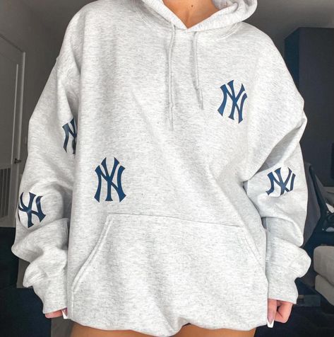 Custom Yankees hoodie. Size featured in photo is size XL.  Material is 50% cotton, 50% polyester. WASH INSTRUCTIONS __ ♥ Wash INSIDE OUT ♥ Wash in cold water ♥ Use mild detergents ♥ Dry on low setting or hang dry New York Yankees Hoodie, Yankee Sweatshirt, Yankee Hoodie, Yankees Sweatshirt, Etsy Sweatshirts, Ny Hoodie, Yankees Hoodie, New York Hoodie, Ny Style