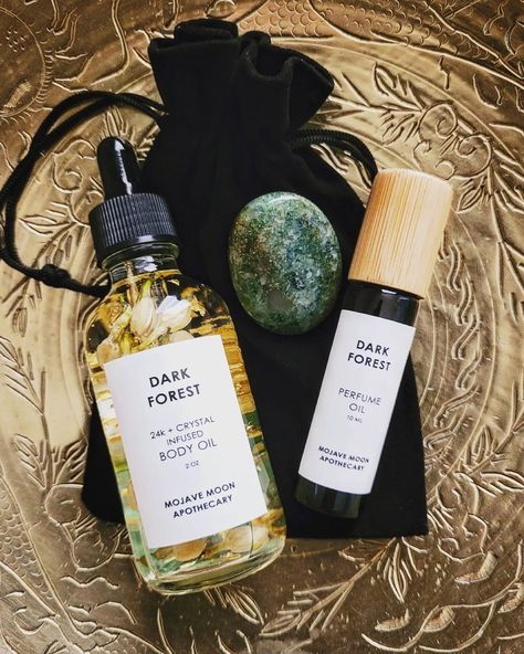 Introducing our new self care bundles in our two best selling scents. Includes one body oil, one perfume, and one worry stone packaged in a black velvet bag. Choose from Dark Forest & Aventurine or Desert Rose & Rose Quartz. Body Oil Packaging, Labeling Ideas, Mojave Moon, Skincare Lifestyle, Homemade Perfume, Skincare Branding, Fragrance Ingredients, Products Photography, Herbal Apothecary