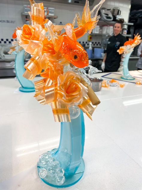 My experience participating in the Sugar Art Essential Techniques class at Le Cordon Bleu London, including the creation of an intricate goldfish themed sugarwork sculpture made using a mix of blown, pulled, and poured sugar techniques. Pulled Sugar Art, Blown Sugar, Sugar Sculpture, Confectionary Art, Art Essentials, Sugar Art, Goldfish, Sculpture, London