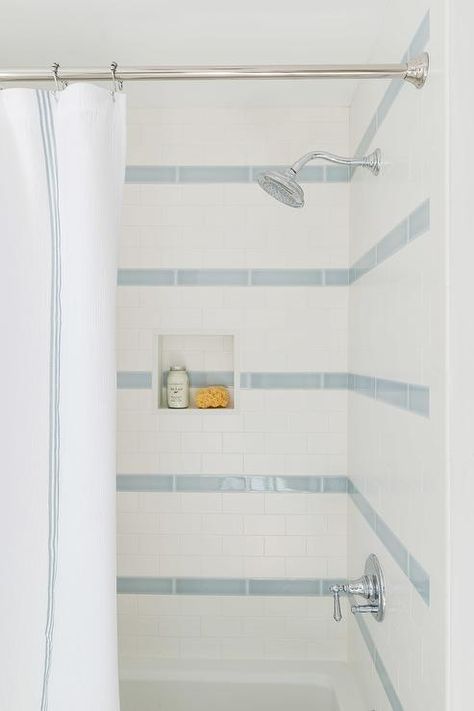 White and blue shower tiles in a stripe pattern add a spa-like finish keeping the theme calm and timeless. Fun Kids Bathroom, Blue Shower Tile, Shower Tiles, Striped Tile, Shower Wall Tile, Boy Bath, Wet Room, Boys Bathroom, Bathroom Reno